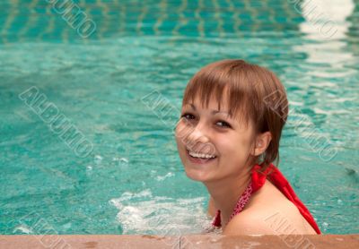 Beautiful girl in pool smiles