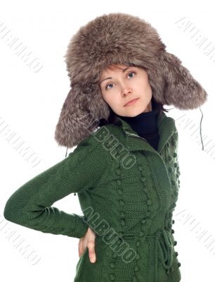 Beautiful girl in green sweater and fur hat