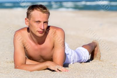 A young man in white pants