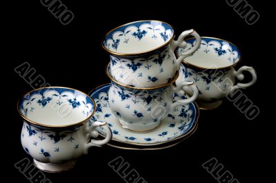 Four tea cups on saucer