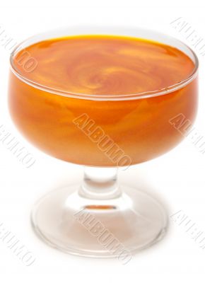 Orange mother-of-pearl jelly in transparent glass