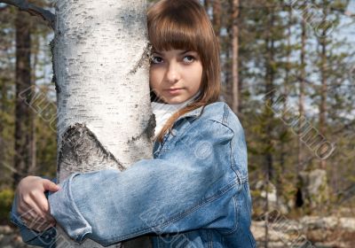 Young beautiful girl and birch