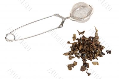 Dry green tea and strainer