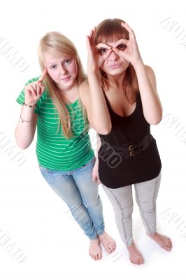 Two girls stand and make faces