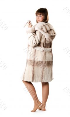 A beautiful young girl in a fur coat