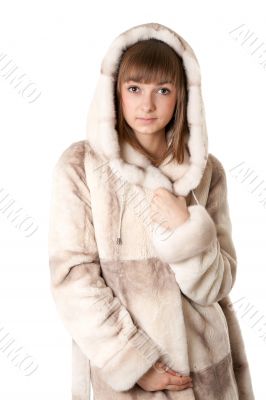 A beautiful young girl in a fur coat