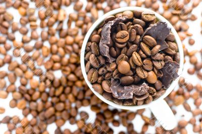 white cup with coffee beans