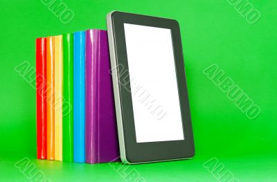 Row of colorful books and tablet PC