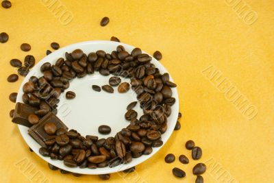 Saucer with coffee beans and chocolate bars