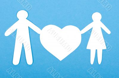 Closeup of paper people with a big heart on white background