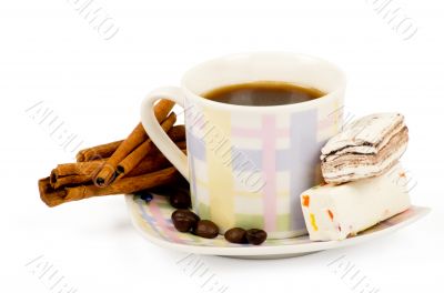 Coffee cup with sweets an cinnamon on white background