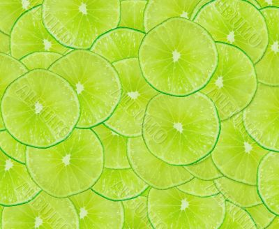 Green background with citrus-fruit of lime slices