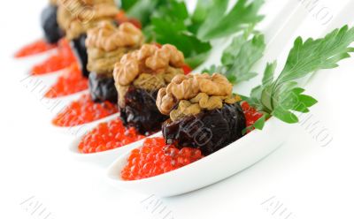 Prunes stuffed with liver pate with nuts in a red caviar