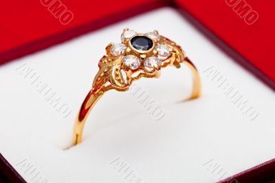 Gold ring with white and blue zirconia enchased