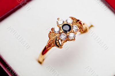 Gold ring with white and blue zirconia enchased