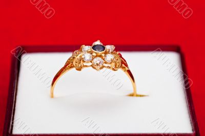 Gold ring with white and blue zirconia enchased