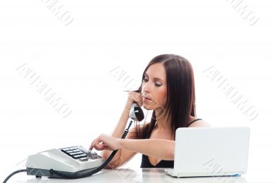Secretary girl with an old phone and laptop