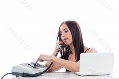 Secretary girl with an old phone and laptop