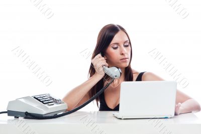 Secretary girl with an old phone and laptop