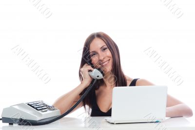 Secretary girl with an old phone and laptop