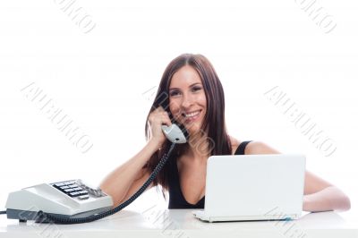Secretary girl with an old phone and laptop