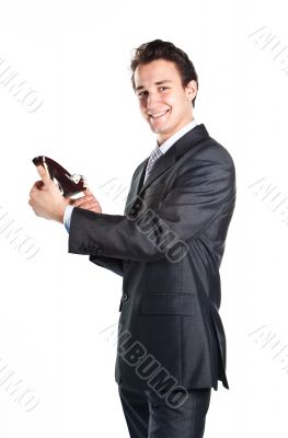 Young businessman with women's shoes