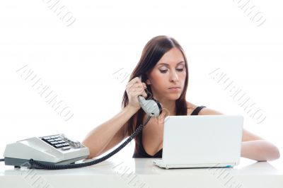 Secretary girl with an old phone and laptop