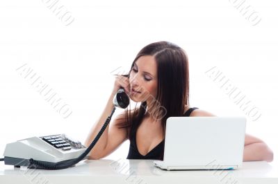 Secretary girl with an old phone and laptop