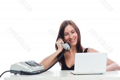 Secretary girl with an old phone and laptop