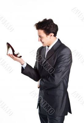 Young businessman with women's shoes