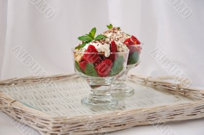 Strawberries with biscuit pieces with mint whipped cream under