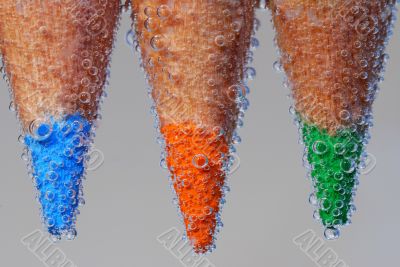 three colored pencils with bubble