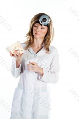 Female doctor with a human skull in his hands