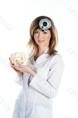 Female doctor with a human skull in his hands