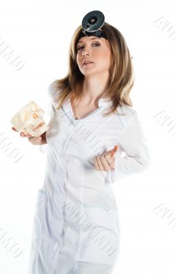 Female doctor with a human skull in his hands