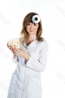 Female doctor with a human skull in his hands