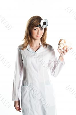 Female doctor with a human skull in his hands
