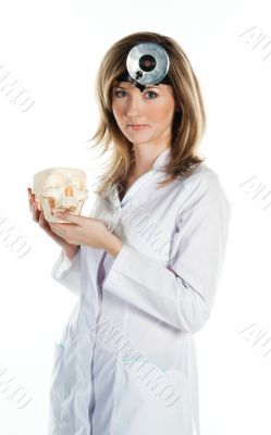 Female doctor with a human skull in his hands