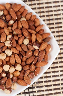 Roasted almonds and hazelnuts on a plate