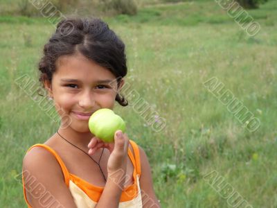 Beautiful girl with a delicious green apple