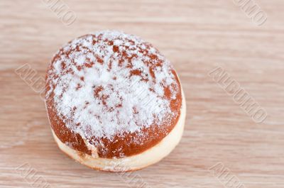 Donut sprinkled with powdered sugar