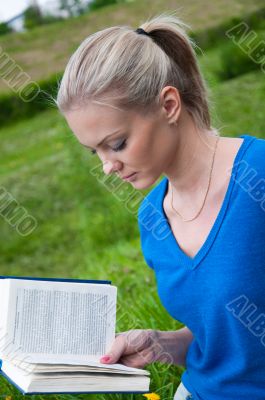 A girl student with a book in the park