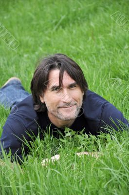 Man, lying on green grass