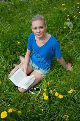 A girl student with a book in the park