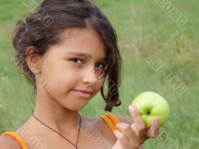 Beautiful girl with a delicious green apple