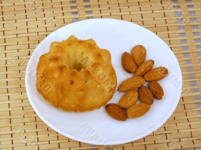 Cake with roasted almonds on a white plate  