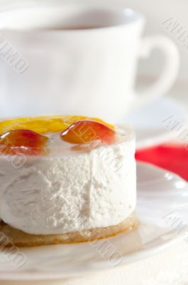 Delicious cake with fresh fruit and tea