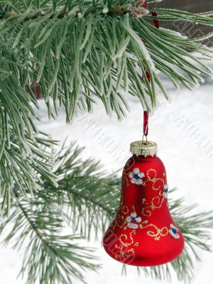 A beautiful red Christmas decorations on a snowy Christmas tree