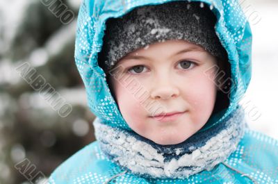 Portrait of a boy with wet snow from the face of