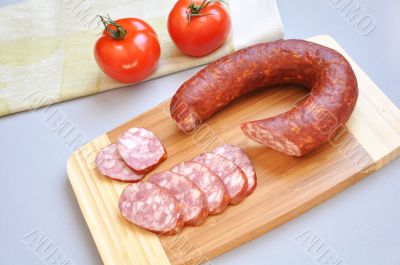 Mouth-watering smoked sausage and ripe tomatoes 